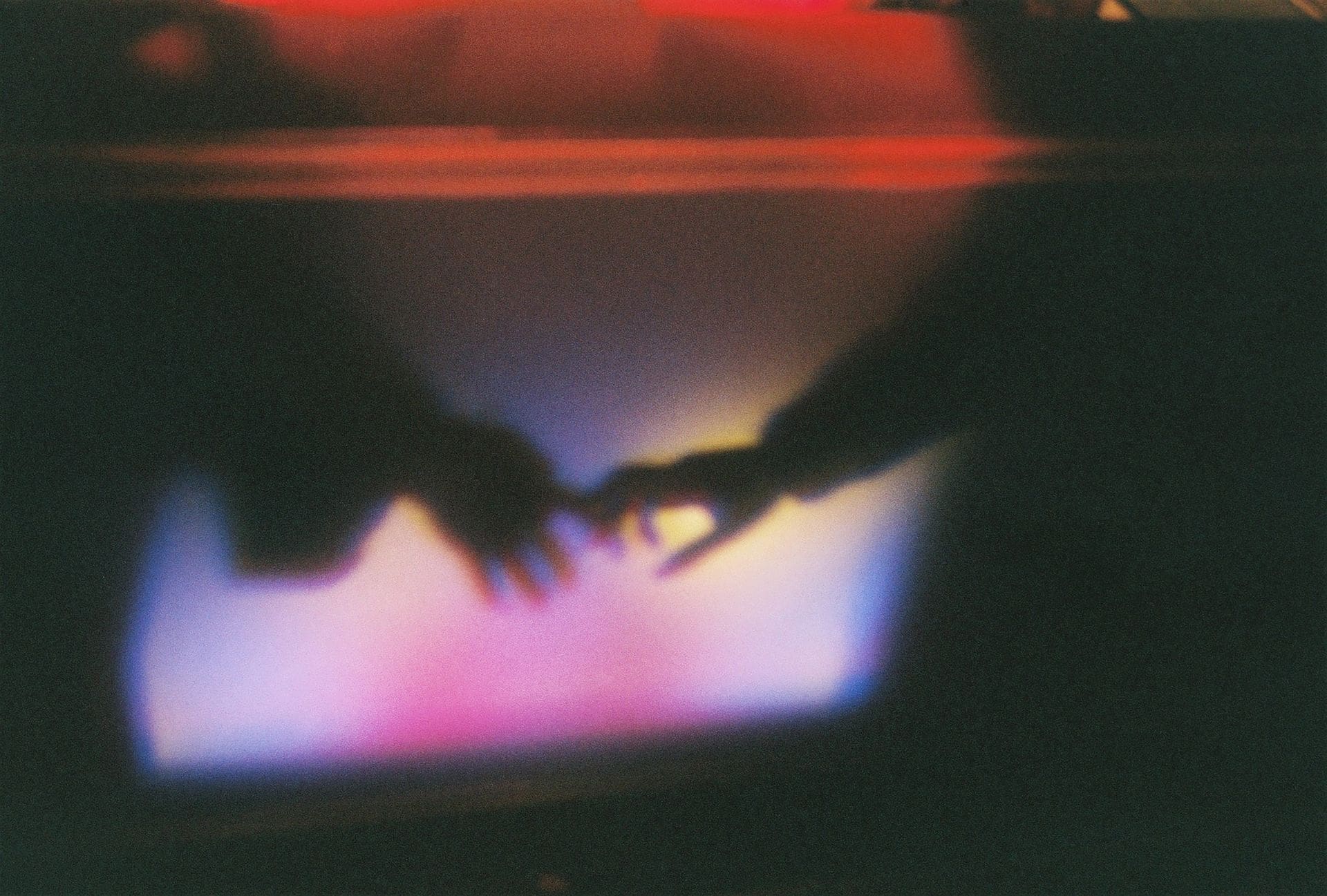 shadow of two hands reaching for one another