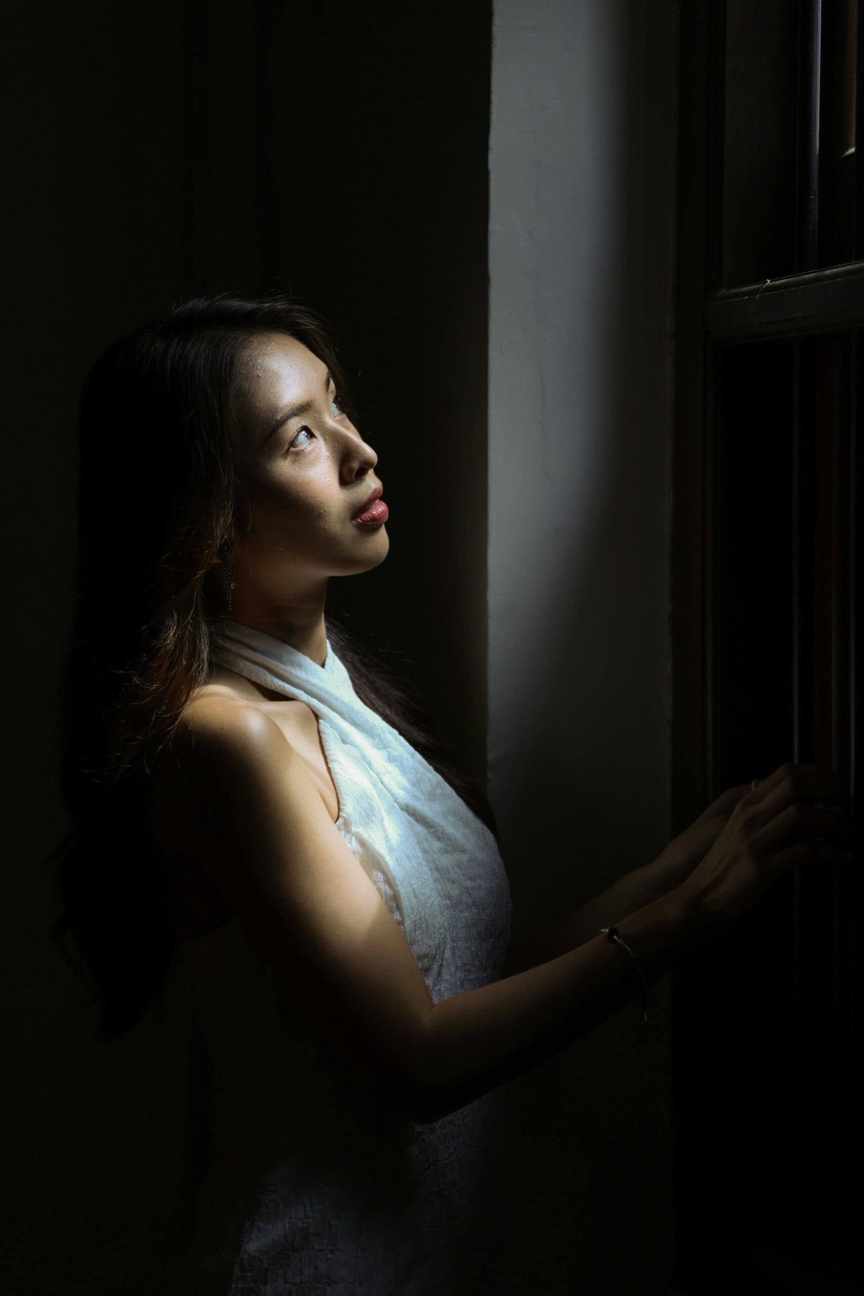 woman looking towards the light of a window