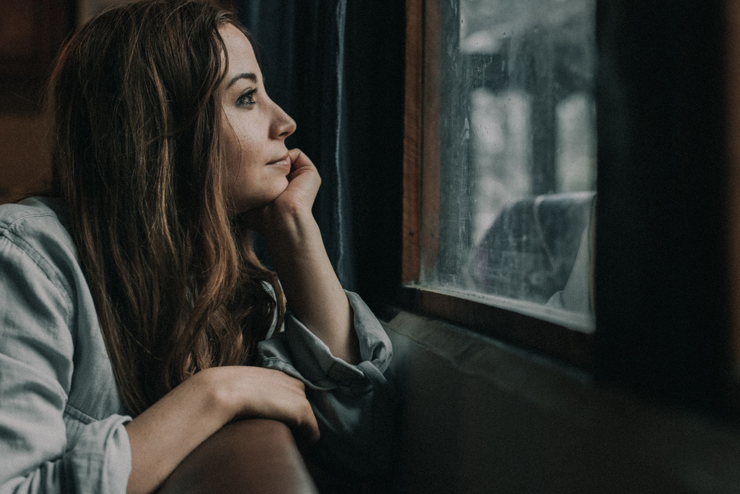 Woman looking through a window