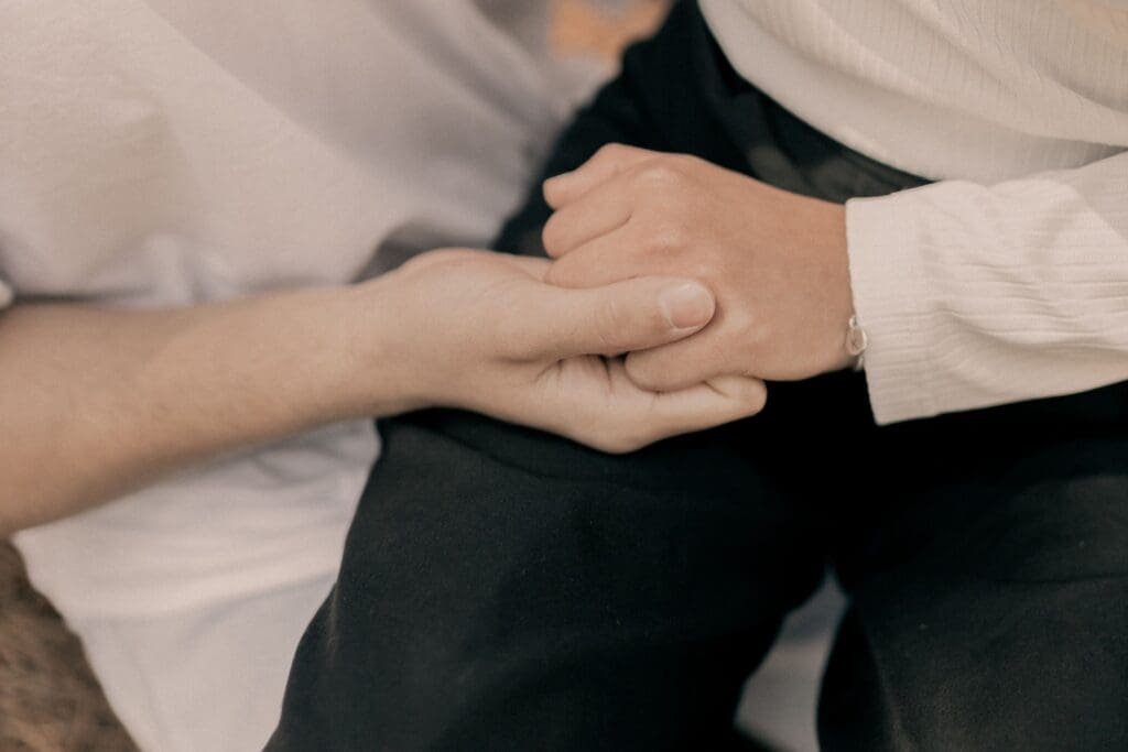 Two hands holding one another